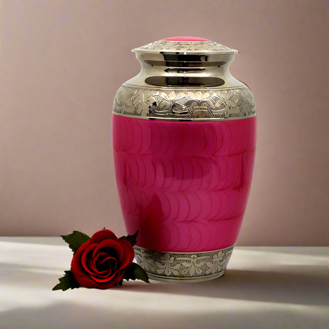 A pink brass metal urn next to a rose