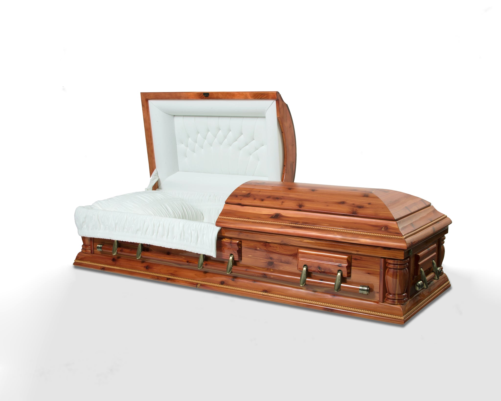 American cedar casket, with matte finish and natural wood grains exposed. Soft white velvet interior. 