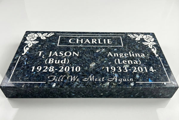 Memorial stone with engraved names and dates on a white background