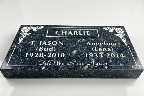 Memorial stone with engraved names and dates on a white background