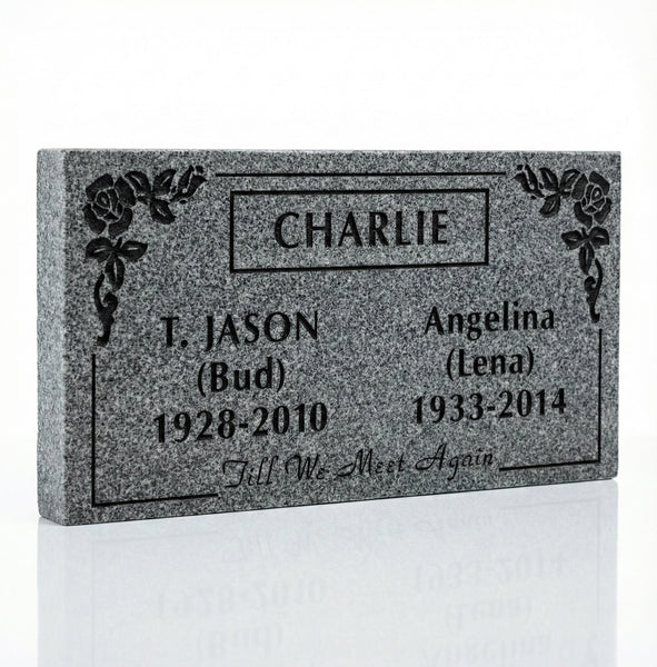 Gray granite headstone with engraved names and dates on a white background