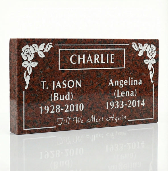 Memorial marker with engraved names and dates on a white background