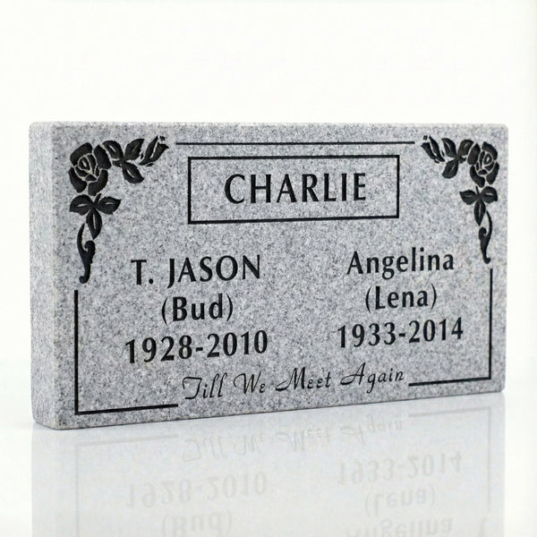 Memorial plaque with engraved names and dates on a white background
