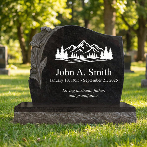 Black marble gravestone with engraved mountain and tree design, name, and dates in a cemetery.