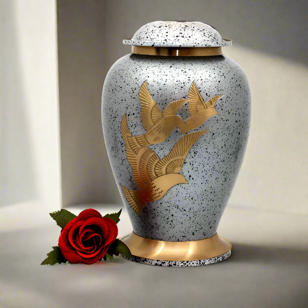 Silver metal urn with golden doves