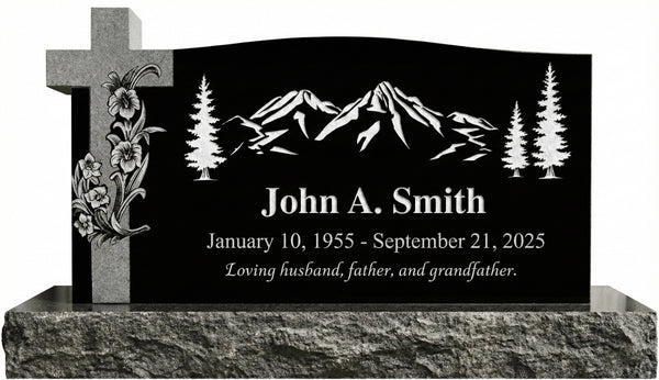 Black granite headstone with engraved mountain design, cross, and trees on a white background.