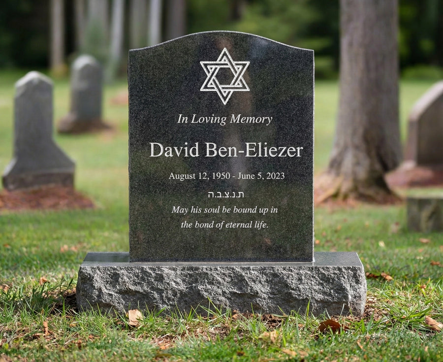 Gravestone with cross design and engraved text in a cemetery