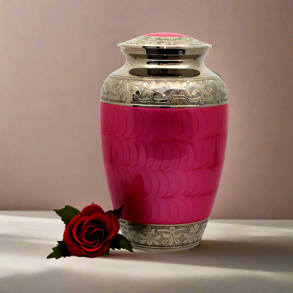 A pink brass metal urn next to a rose 