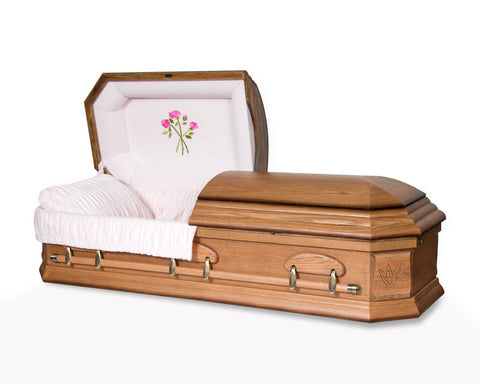 Lady's Octagon oak casket with intricate corner carvings. Pink interior with embroidered roses. - Casket Depot Vancouver